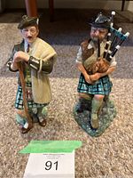 Photo of two Royal Doulton figurines, The Laird and The Piper, showing front view and details