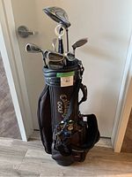 Full view of black Callaway Golf stand bag with clubs set inside, showing the bag design and overall lot appearance.