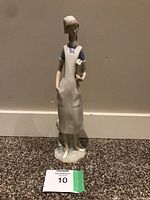 Front view of the Lladro nurse figurine showing detailed face, nurse cap, uniform and book in hand.