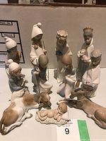 Front view of all 11 figurines arranged in semicircle