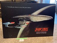 Full view of Star Trek The Next Generation picture showing U.S.S. Enterprise near planet with text "To boldly go where no one has gone before."