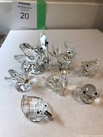 Photo of all 7 Swarovski crystal animal ornaments arranged on white surface