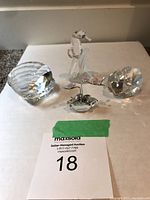 All four Swarovski crystal ornaments shown together on a white surface, including a seahorse, clam shell, and two heart shapes.