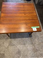 Top view of teak coffee table showing surface and dimensions sticker