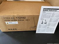 Box of the KAKA Industrial Hand Lever Shear model HS-6 with the operation manual placed in front.