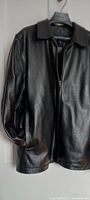 Front and side view of men's black leather jacket by Gap showing zipper closure and slash pockets