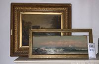Main image showing both paintings: narrow seascape in front of larger framed landscape