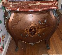 Front view of Bombay chest showing floral inlay on the drawers and wood finish.