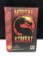 Front cover of the Sega Genesis Mortal Kombat game case displaying title and logo.