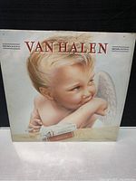Front cover of Van Halen 1984 album, showing cherub artwork with cigarette and album title in red text.