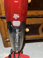 Close up of Dust Devil Power Swerve label on the vacuum body