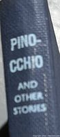 Spine of the book with white text 'PINOCCHIO AND OTHER STORIES' on dark blue background.