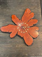 Full view of live edge wood wall clock showing wood grain, natural bark edges, and clock hands.
