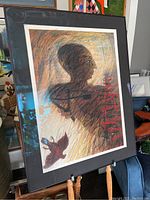 Framed artwork showing the entire image of the side profile figure with layered lines and colors.