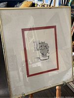Full view of the framed lithograph showing a gray cartoon elephant holding a sign and the artist signature below the image.