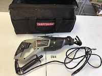 Craftsman reciprocating saw laid out beside the zippered black tool bag with Craftsman logo