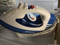 Close up of Oreck lightweight iron showing controls and blue-white design