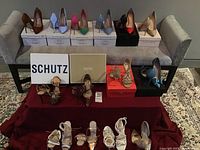 Front view of top shelf showing eight pairs of pointed-toe pumps in assorted colors on original boxes