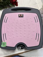 Top view of the Body Sculpture foot pedal with pink textured platform and gray frame.