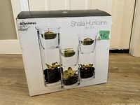 Box front showing Bowring Shalia Hurricane Set of 3 candleholders with image and price sticker