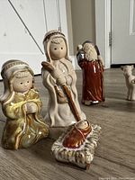 Front view of Mary, Joseph, baby Jesus figurines grouped together