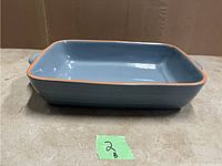 Side view of blue and terracotta rectangular baking dish showing clean condition