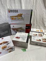 Photo of all serving dish boxes stacked showing Moda Concept and Libbey branded items