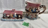 Noah's Ark ceramic butter dish and pitcher side-by-side showing animal details and overall design