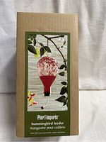Box front showing image and product name of Pier 1 Imports hummingbird feeder
