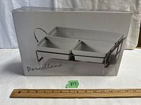 Photo of the original packaging showing the design and layout of the serving set with porcelain dishes in chrome caddy.
