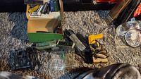 Overview of all included micro gauge metal stamp trains and accessories on carpet floor, with boxed and loose components visible.