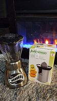 Oster 16-speed blender with glass pitcher and Juiceman juicer box shown together.