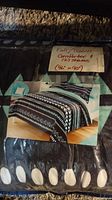 Photo of packaged comforter and pillow shams with label showing Full/Queen size and dimensions 86x90 inches, displaying the comforter pattern.