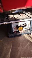 Close-up of the Ryobi table saw top surface and adjustment handle