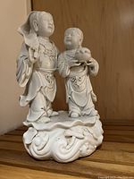 Frontal view of the sculpture showing both figures and base