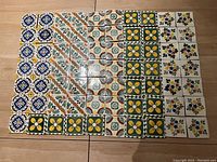 Top-down view of all 70 tiles arranged in rows showing five distinct patterns.