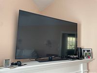 Front view of Samsung 55-inch LED Smart TV on a mantel