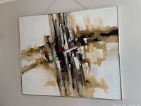 Full view of the signed large abstract painting hanging on a wall showing composition and colors.