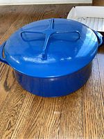 Photo of large blue enameled cast iron pot with lid, showing intact lid and handles