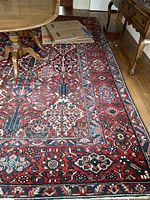 Overall view of rug under dining table on hardwood floor