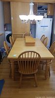 Rectangular oak table with chairs in kitchen setting