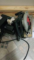 Porter Cable circular saw and Wen all saw placed on floor showing overall condition and cords.