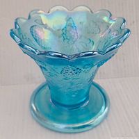 Front photo showing the punch bowl stand with its iridescent blue color and scalloped top edge.