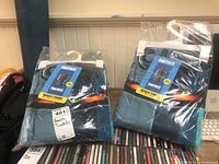 Two original packaged Fortnite beach towels in blue-themed design, visible packaging and hangers included
