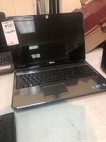 Dell Inspiron N5010 laptop showing the screen and keyboard, no power cord visible
