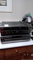 Front view of JVC RX-207 receiver on top of JVC XL-F76 CD changer on counter