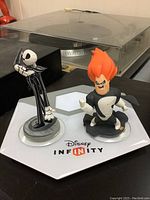 Disney Infinity starter base with Jack Skellington and Syndrome figurines placed on top.