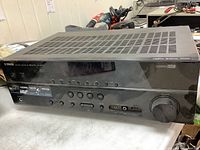 Front view of Yamaha RX-V375 AV receiver showing buttons, ports and volume knob.