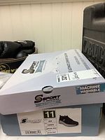 Skechers shoe box with label showing size 11 men's Camron charcoal gray shoe, arch comfort, machine washable.