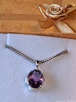 Pendant laid flat in gift box showing stone and chain